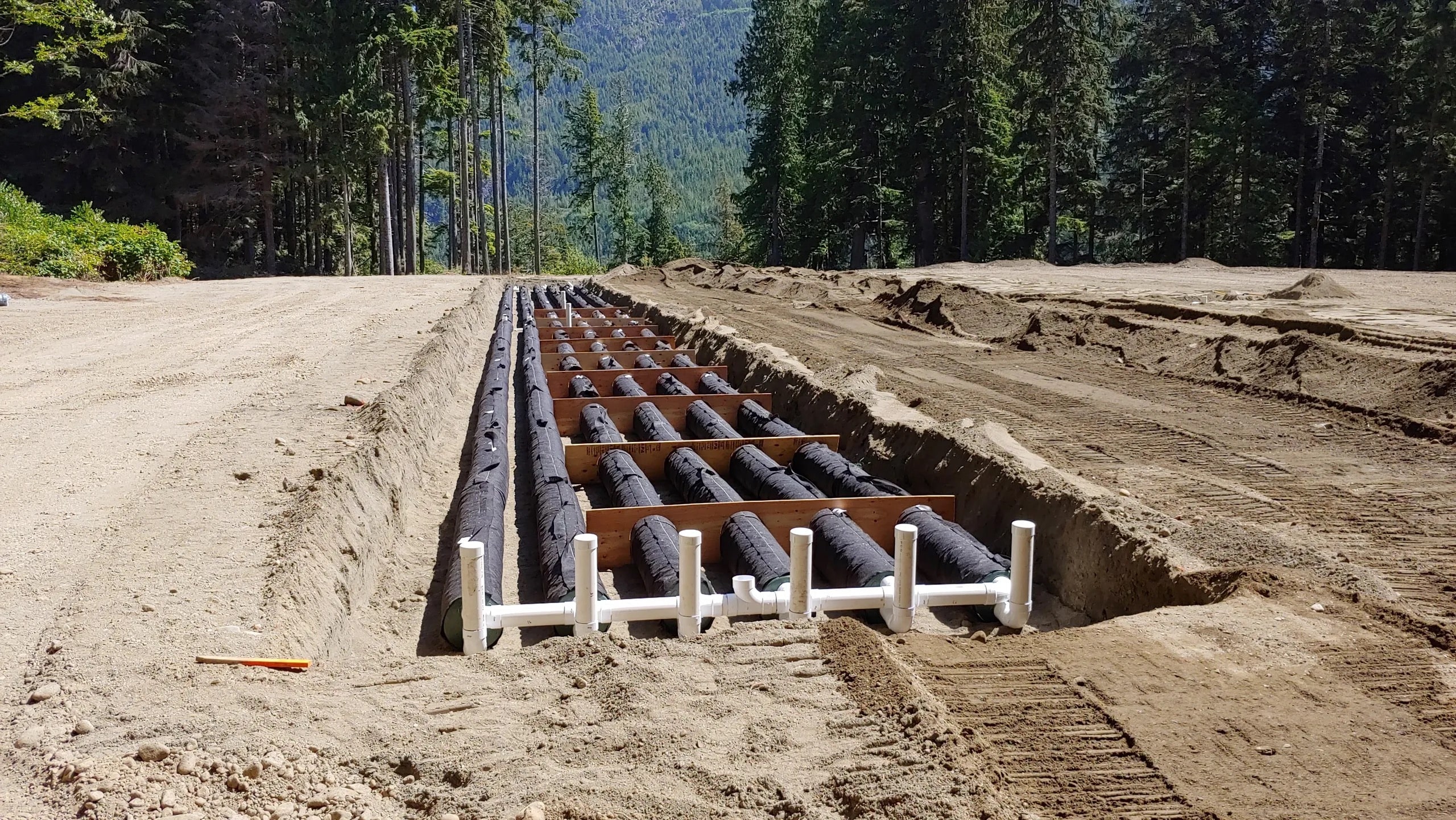 Enviroseptic tubes install, ready for backfill, one of two dispersal fields, commercial system install in Ethlateese Village, FNHA